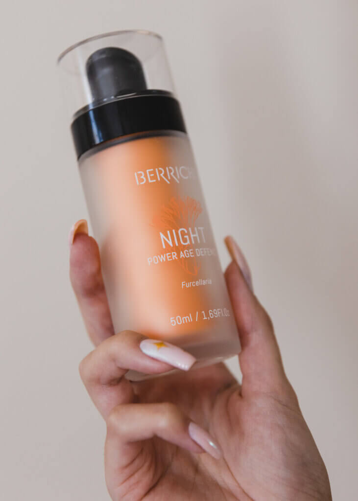 A woman's hand holding Berrichi Night Cream.